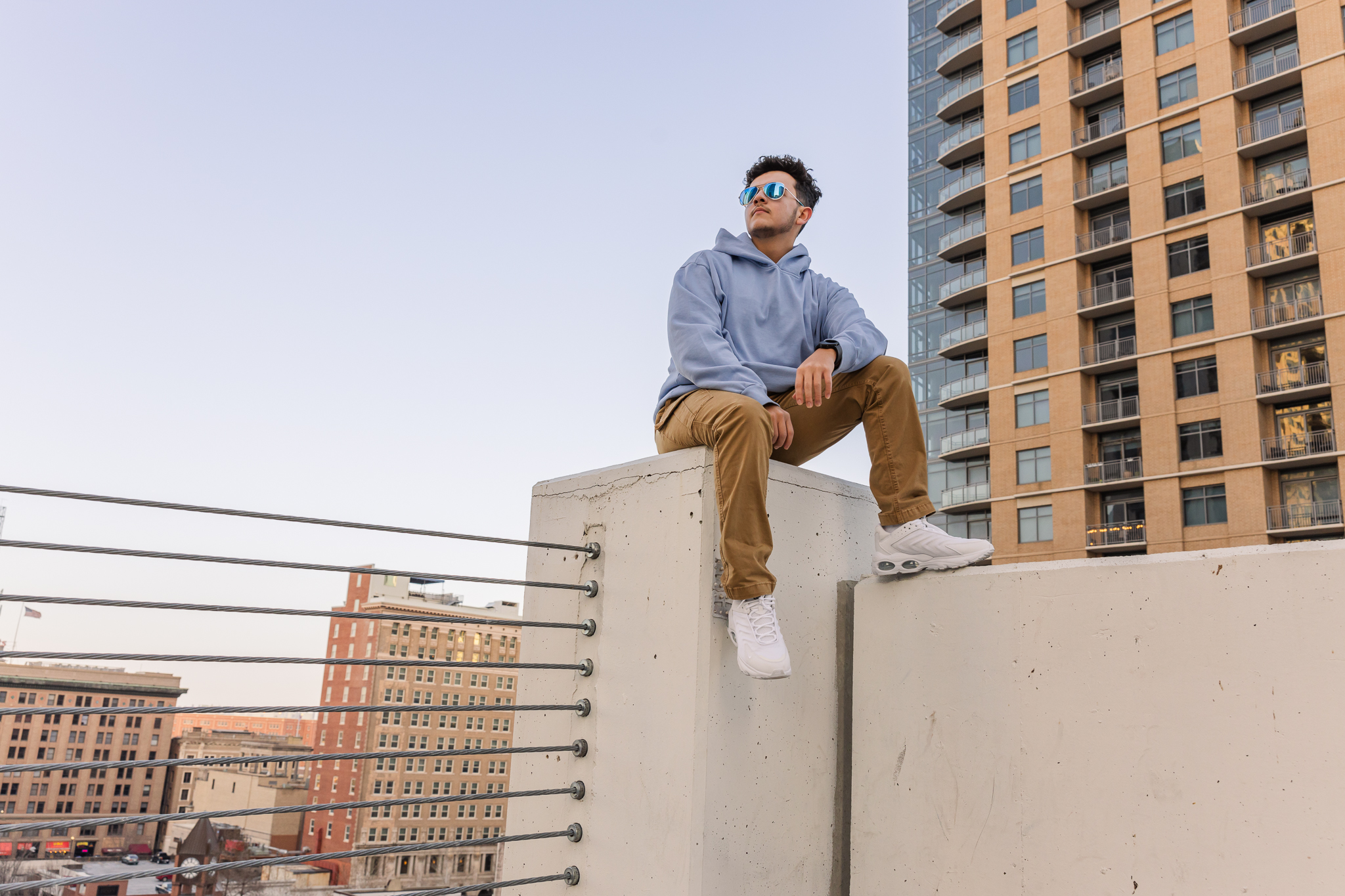 graduating senior boy on downtown rooftop with skyscrapers