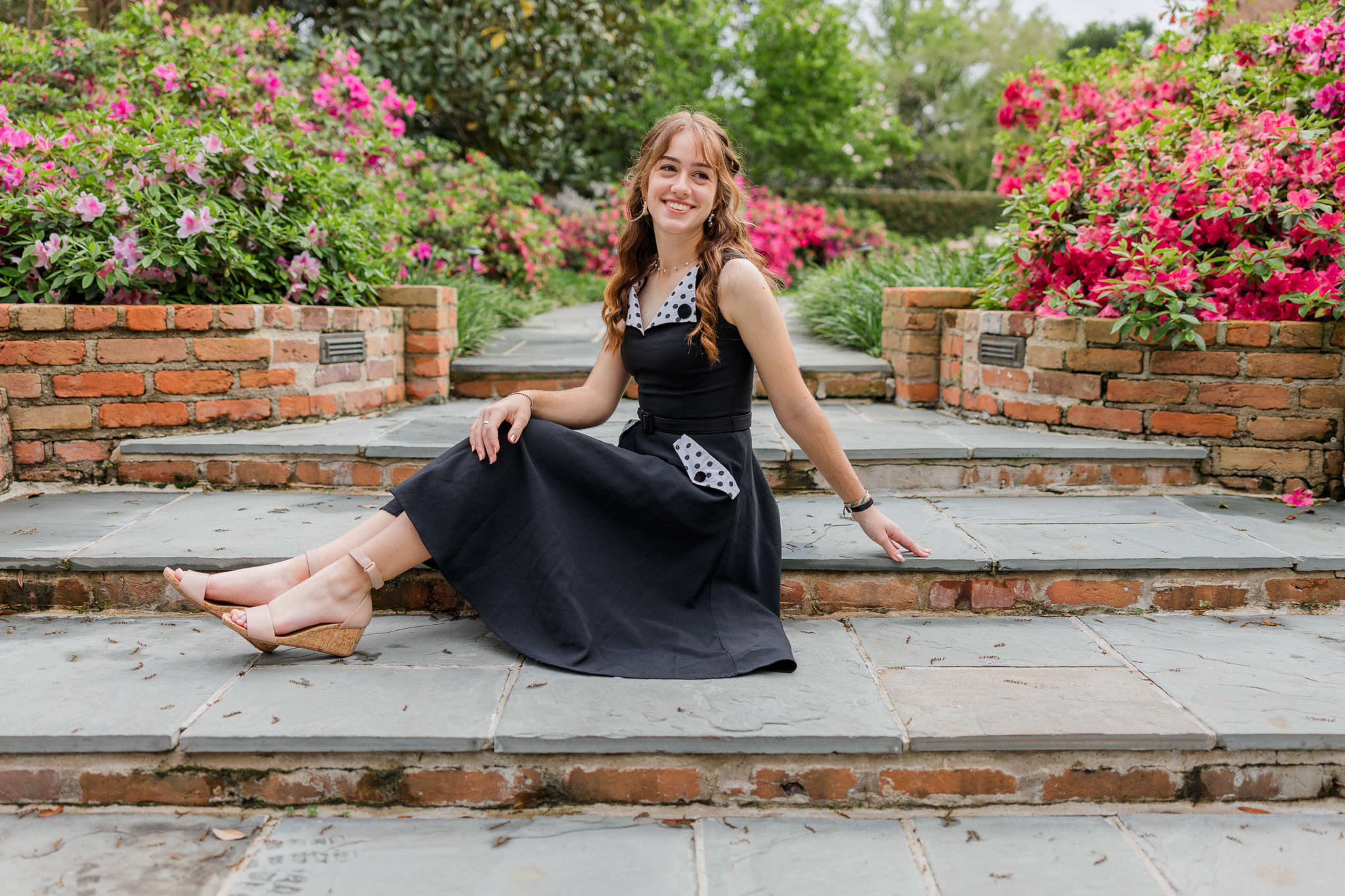 graduating senior girl among spring flowers