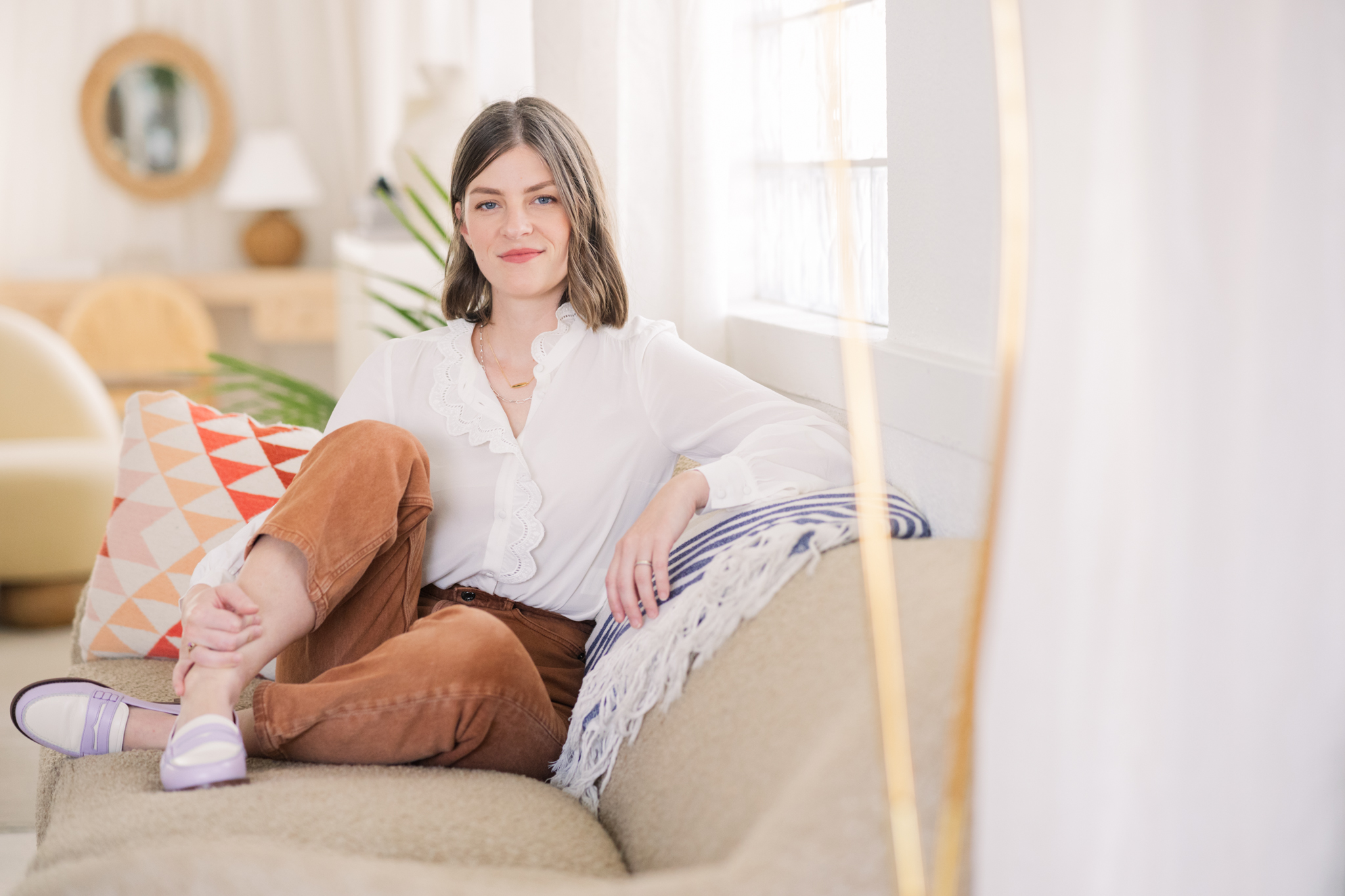 woman on studio sofa with soft furnishings