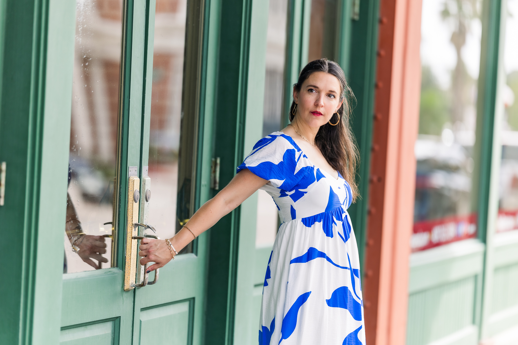 woman in blue and white maxi dress in Galveston architecture